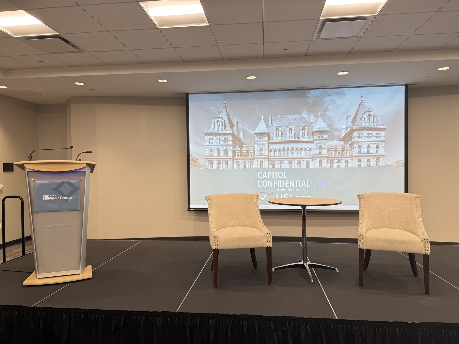 The empty Capitol Confidential Pro stage set with a New York State Capitol backdrop before the taping