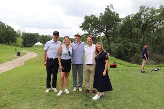 Five golfers posing together on the course at the Senate Republican Caucus Golf Tournament