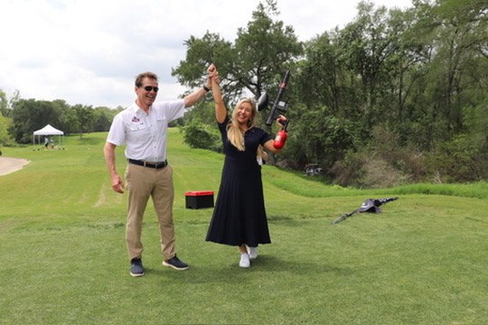 Two golfers celebrating on the course at the Senate Republican Caucus Golf Tournament