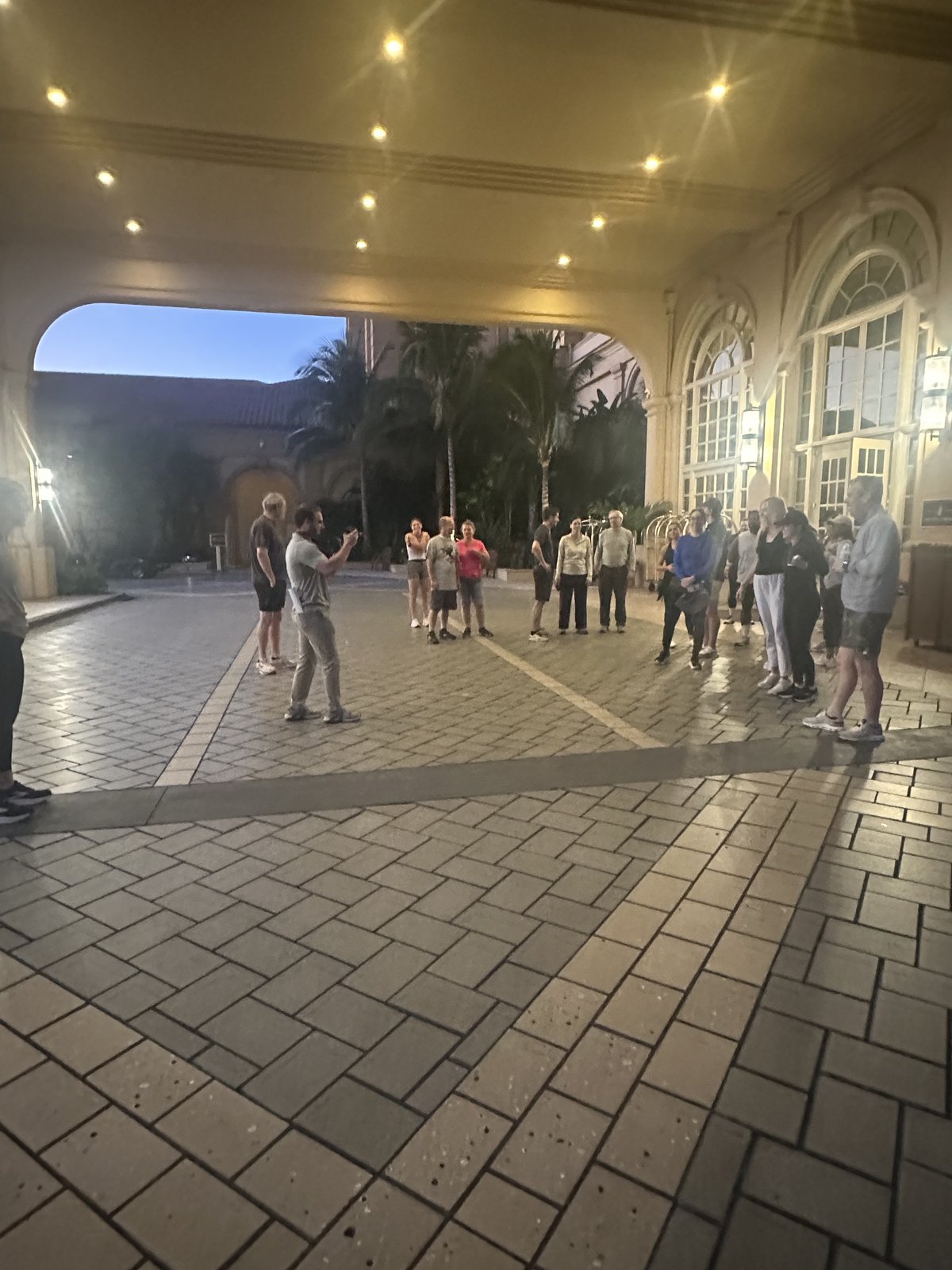 A larger group of SGAC attendees gathered under the hotel portico before the fun run
