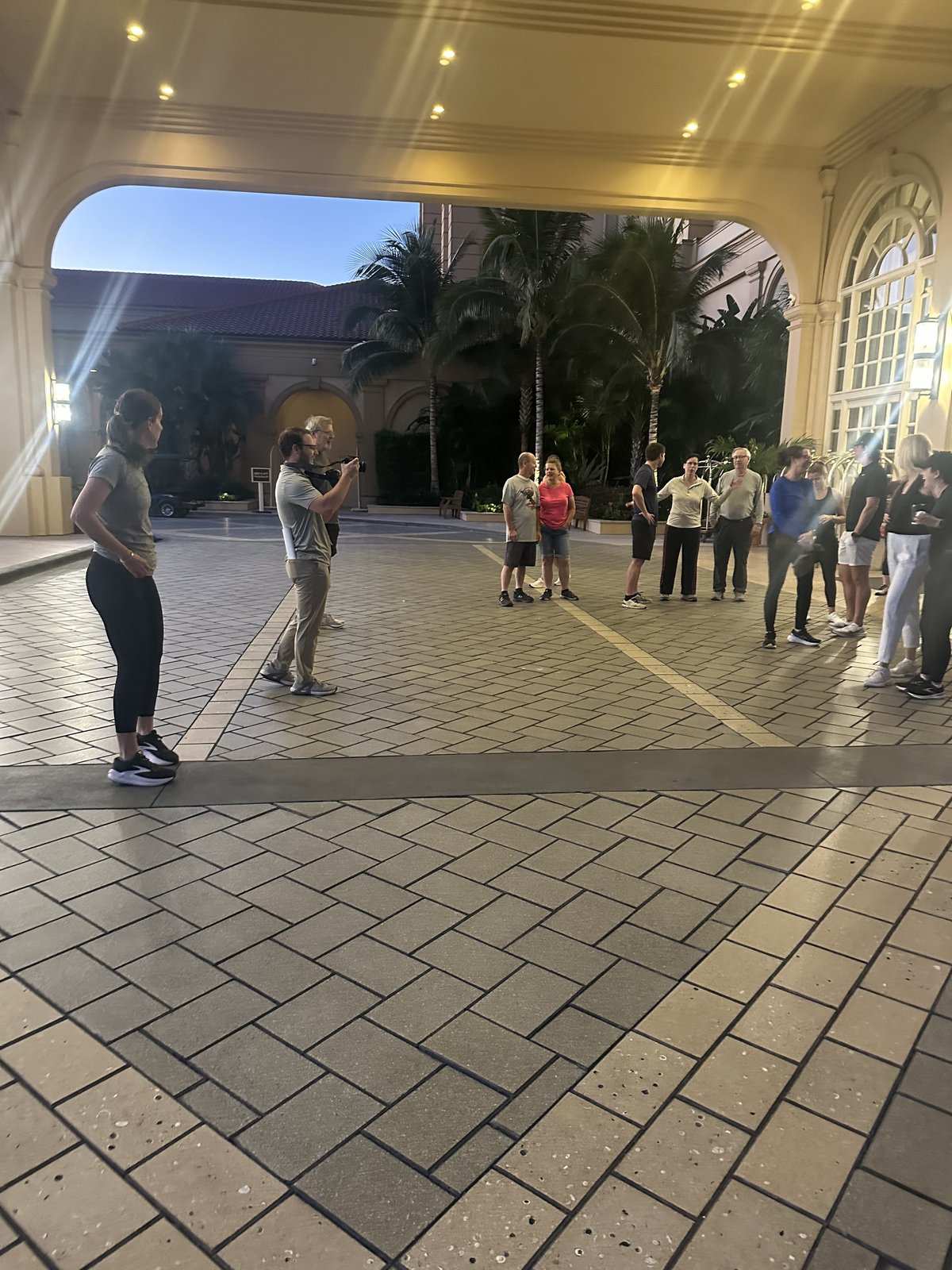 An SGAC attendee photographing the group before the early-morning fun run