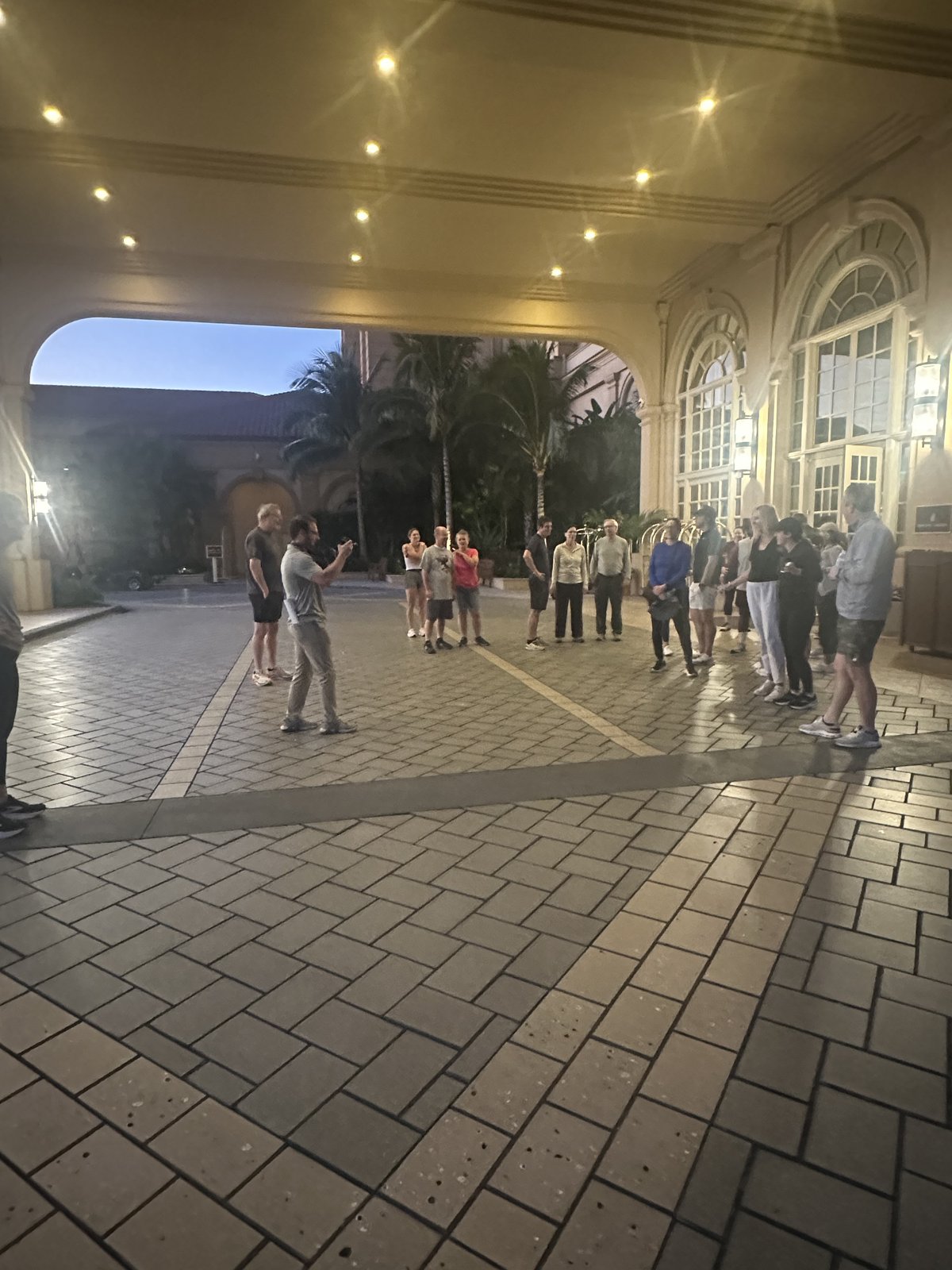 A group of SGAC attendees gathered under the hotel portico before the fun run