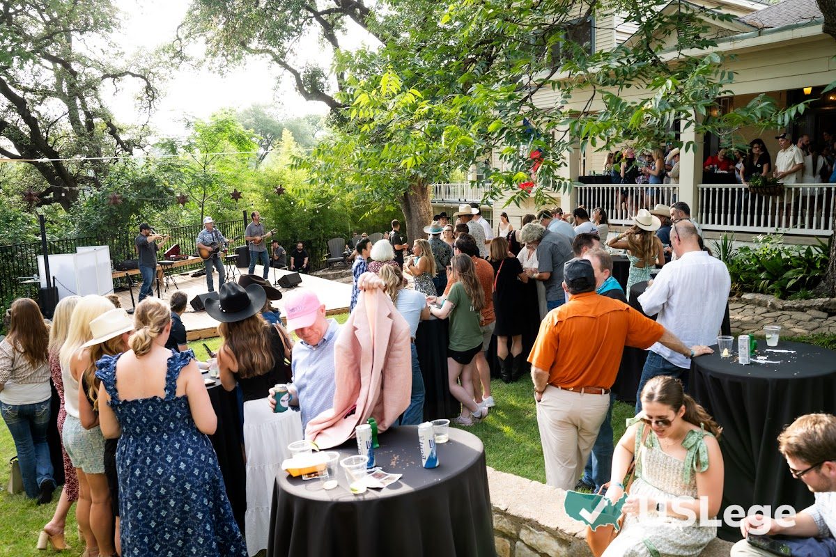 Wide shot of the Sine Die Celebration venue with a live band and a large crowd