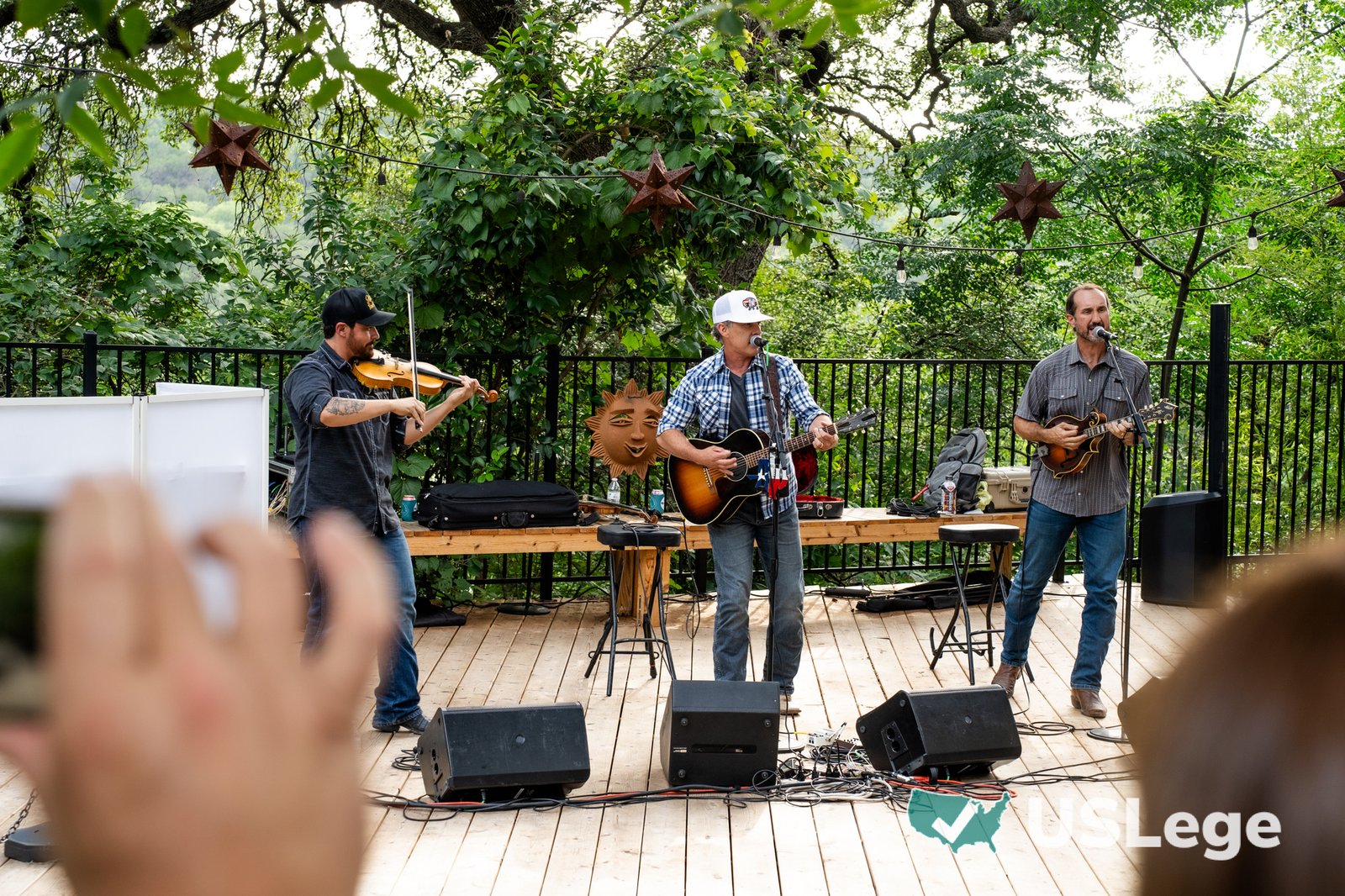 A live band performing on stage at the Sine Die Celebration