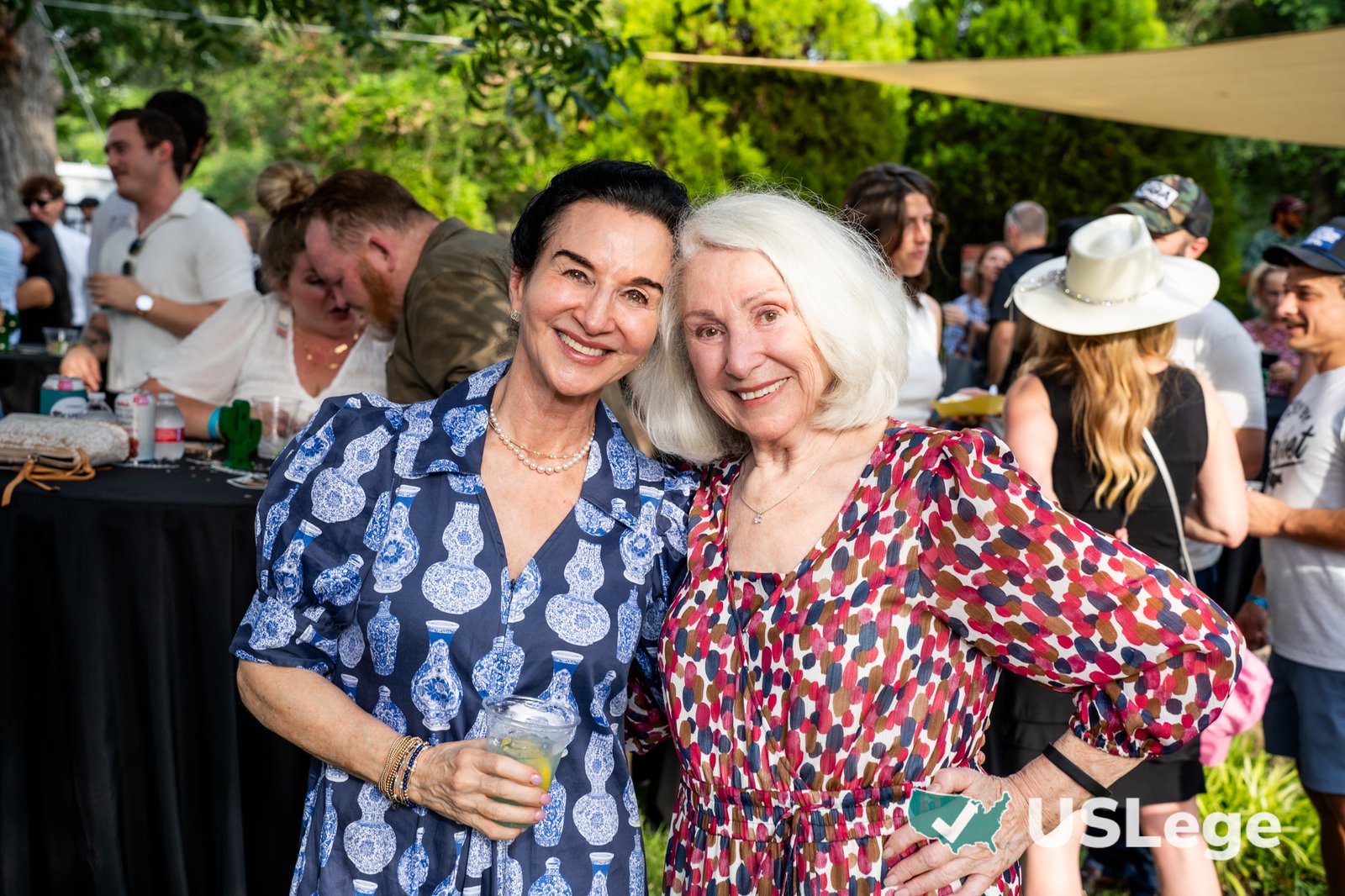 Two guests smiling together at the Sine Die Celebration