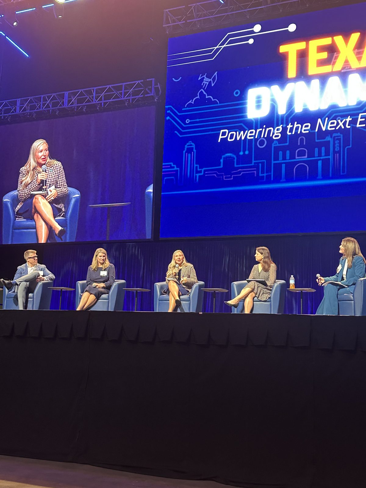 Laura Davis speaking on the Texas Dynamism panel, shown on the jumbotron screen